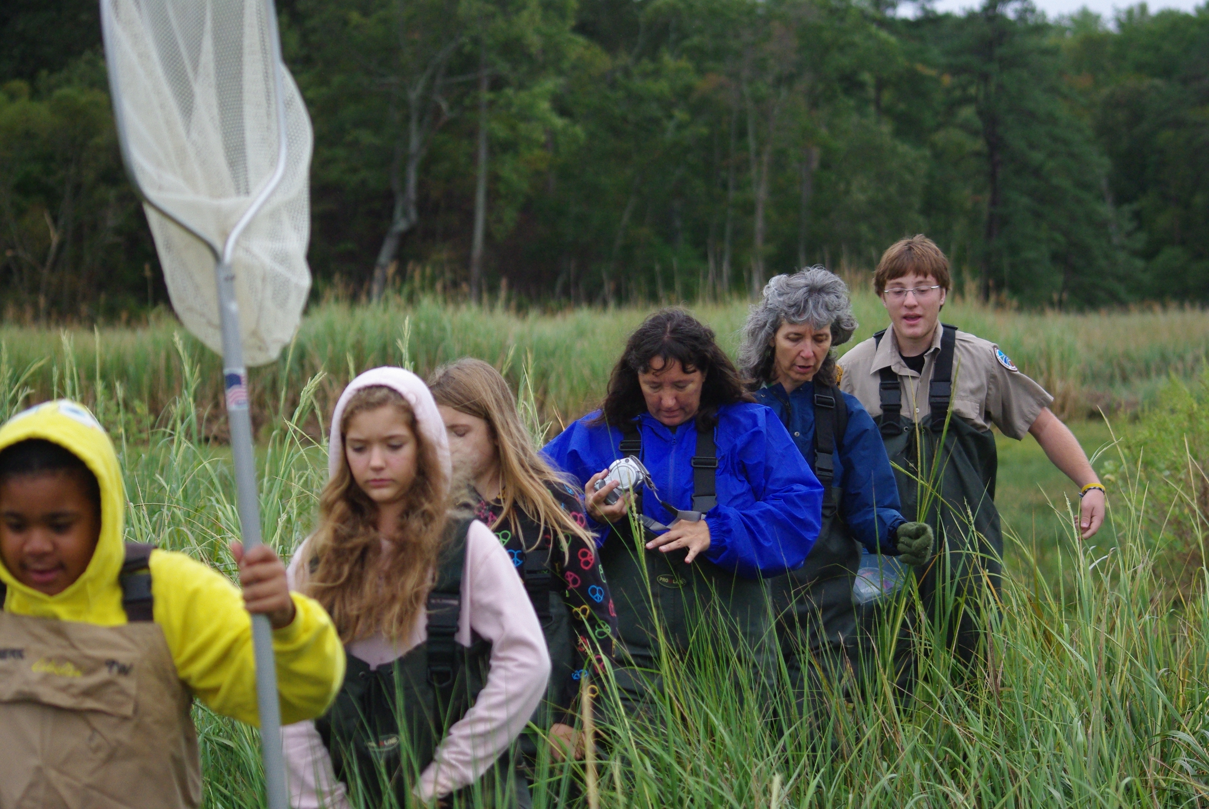 Young people taking part in a supervised outdoor learning activity on an estuaries field visit